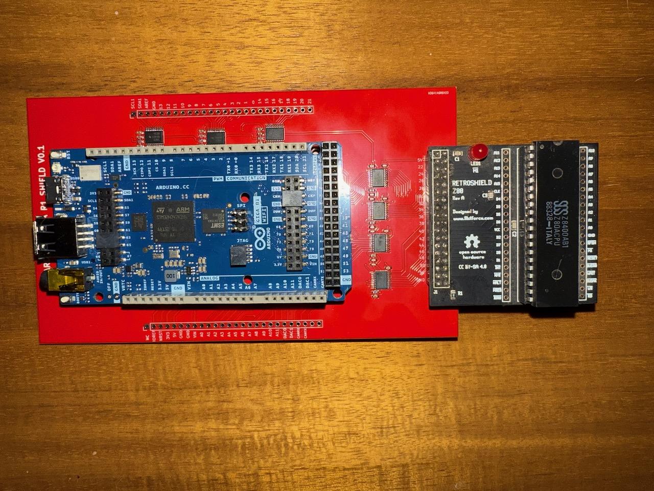 The assembled stack: Arduino Giga R1 WiFi (blue) mounted on the red level converter PCB, with the RetroShield Z80 and its 40-pin Z80 DIP chip partially inserted on the right