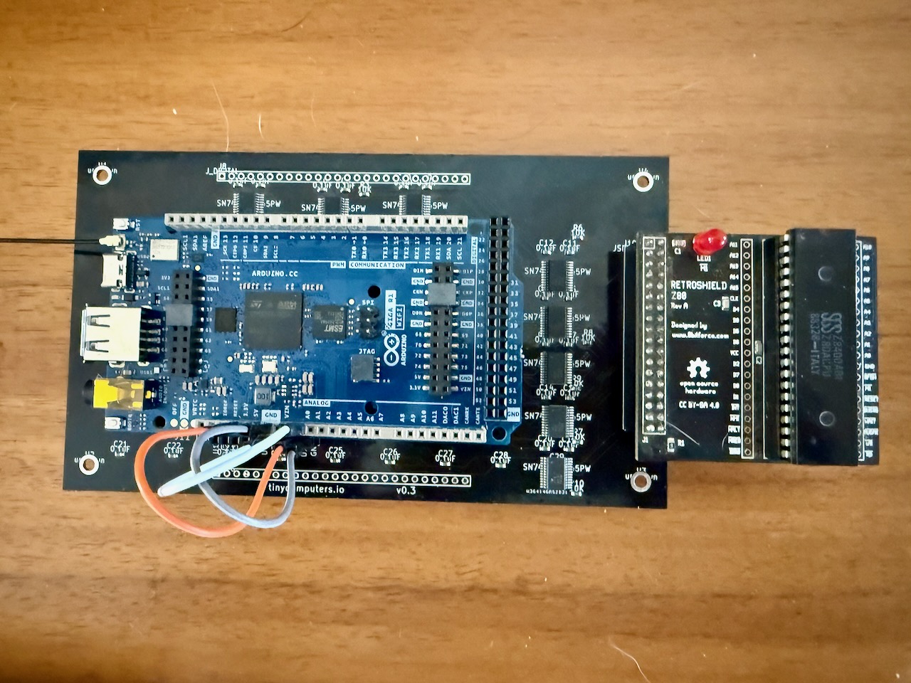 Full test stack: Arduino Giga R1 with GigaShield level converter and RetroShield Z80, connected with jumper wires for DIR control