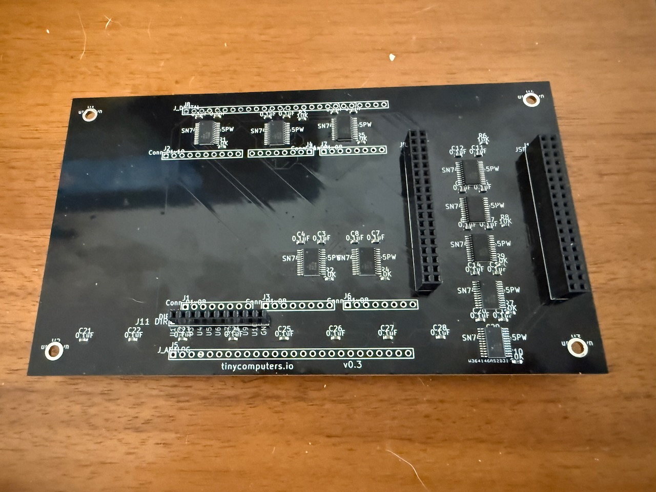 GigaShield v0.3 PCB — black solder mask, ten SN74LVC8T245PW level shifters, fabricated by PCBWay