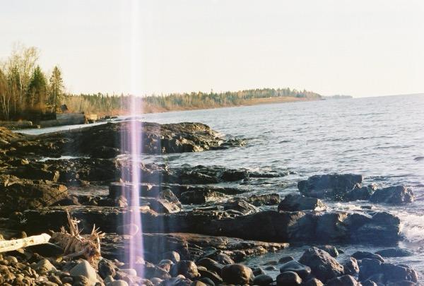 Rocky lakeshore with tilted horizon